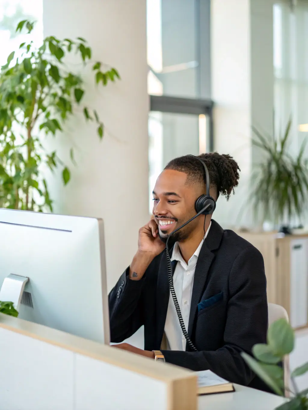 A professional customer service agent smiling while assisting a customer over the phone, showcasing improved customer service with Agent AI Voice.